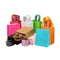 Assorted colorful paper shopping bags on a gray background