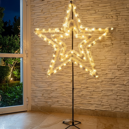 Decorative star-shaped light fixture against a stone wall.