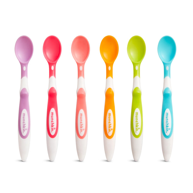 Set of colorful baby spoons with 'munchkin' branding on a white background